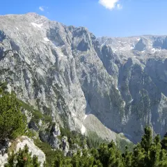Majestätische Bergkulisse mit felsigen Hängen und grünen Nadelbäumen, ideal für eine Kehlsteinhaus Wanderung.
